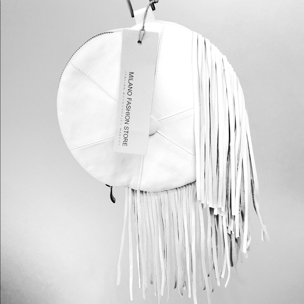 Round white leather handbag with leather fringe.